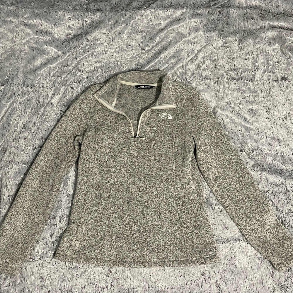 A marble grey, quarter zip North Face sweater. Barely used, size small.